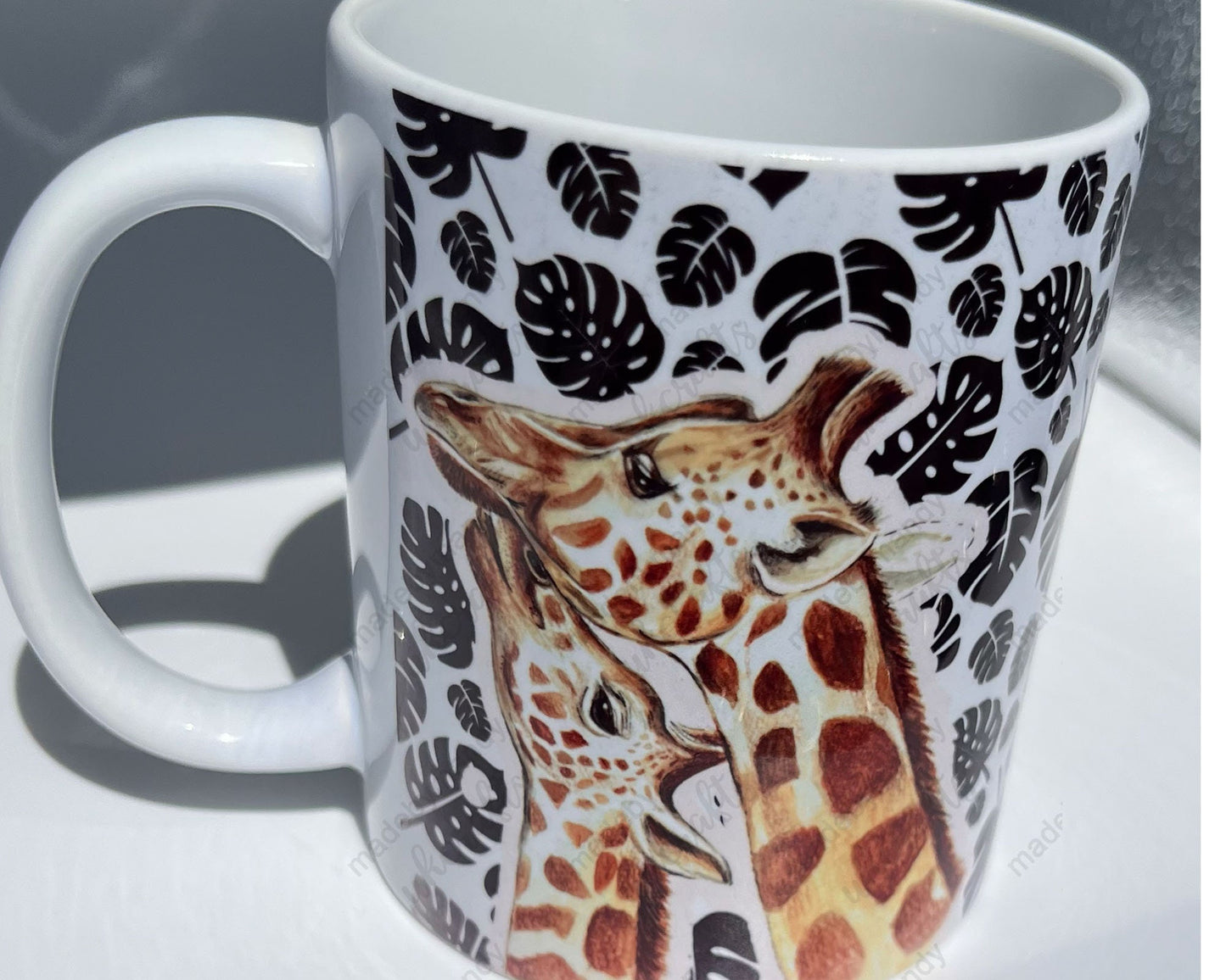 Giraffe and calf themed mug with black Monstera (cheese plant) leaf pattern - Beautiful gift for family, friends or colleagues