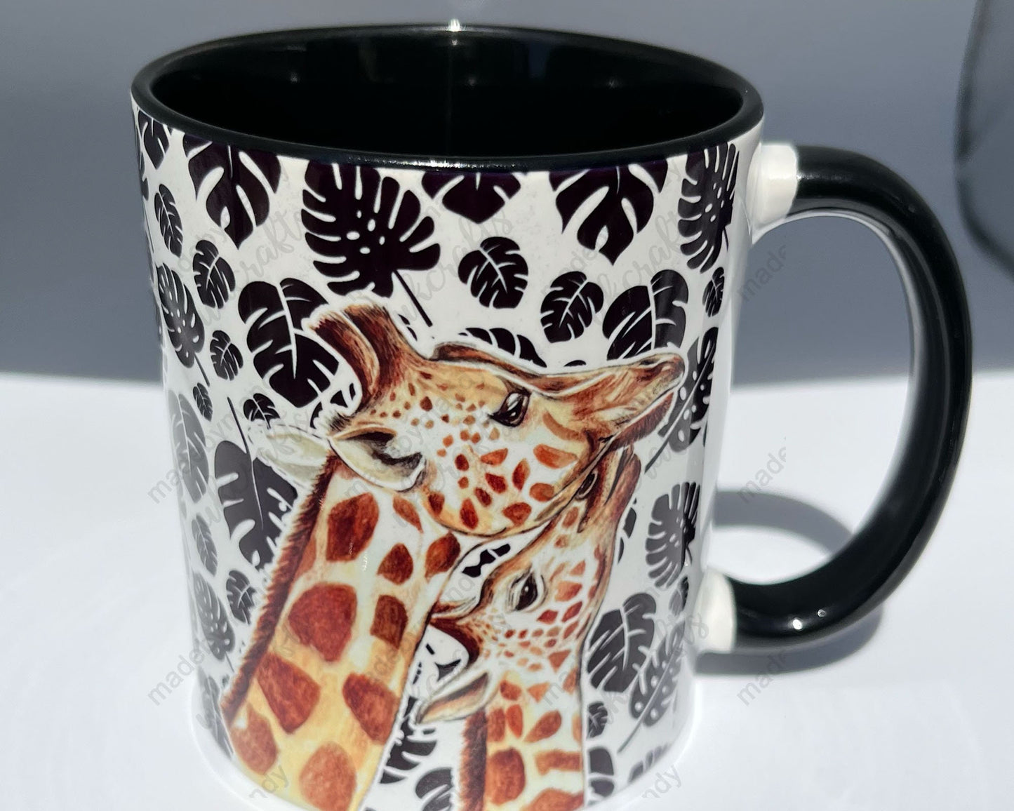 Giraffe and calf themed mug with black Monstera (cheese plant) leaf pattern - Beautiful gift for family, friends or colleagues